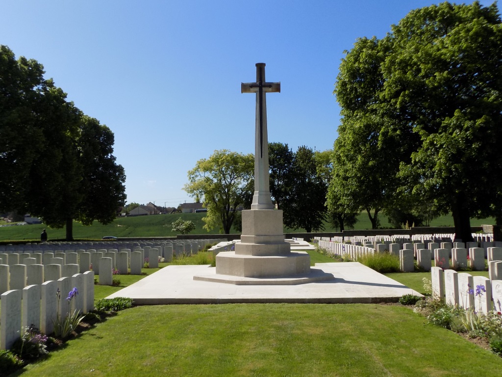 Immaculate stone rows extending across green lawns at Achiet-le-Grand Communal Cemetery Extension, France