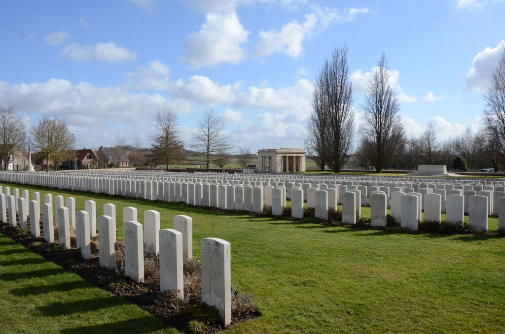 Beautiful landscape view of Bailleul Communal Cemetery Extension, France, showcasing rows of immaculate graves under a clear sky