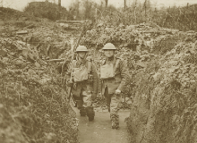 British soldiers standing in knee deep water in a trench.