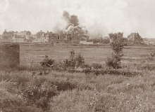 A shell bursts in the outskirts of Lens, August 1917. First major action led by a Canadian commander.